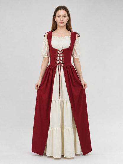 Two-piece burgundy and cream dress shown full-body on a model, with a laced bodice, puff sleeves, and tiered skirt
