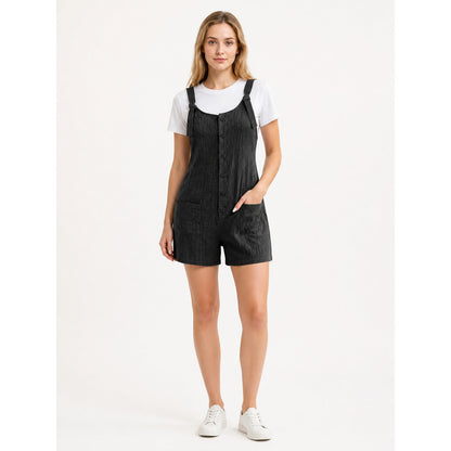 Black bib shorts with adjustable straps, front buttons, and two pockets, shown full-body on a model over a white T-shirt