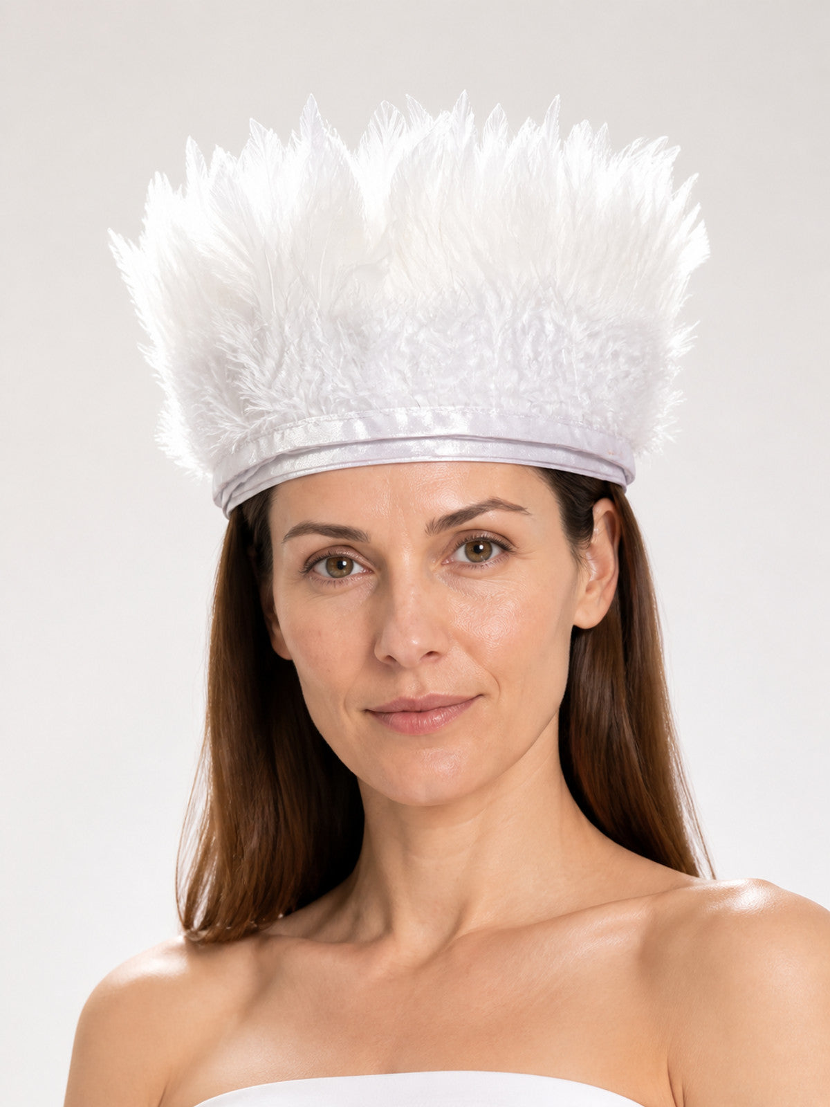 Feather headpiece shown close up on a model, with tall white feathers and a narrow white band