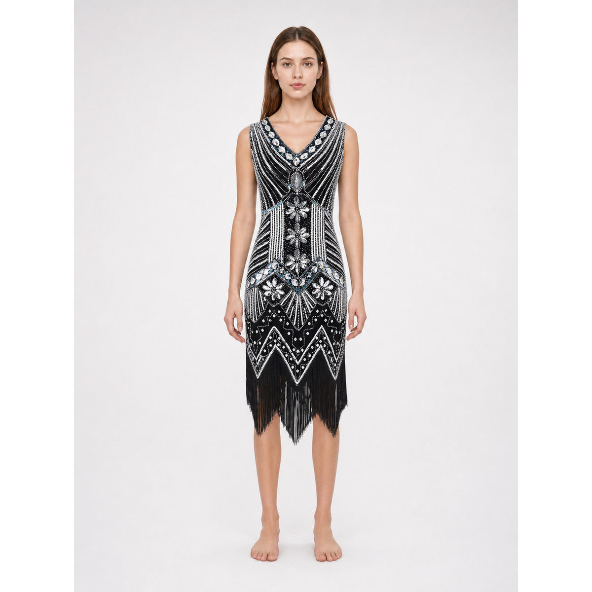 Sleeveless dress with a V-neckline and fitted silhouette, made from fabric featuring prominent bead and sequin embroidery. The decoration combines dense geometric patterns, chevron-shaped elements, and floral motifs, creating a striking loo