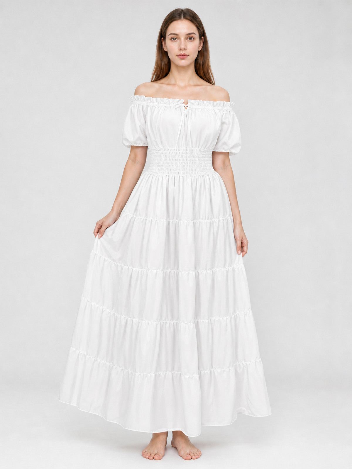 White off-shoulder maxi dress with puff sleeves, smocked waist, and tiered skirt shown full-body on a model