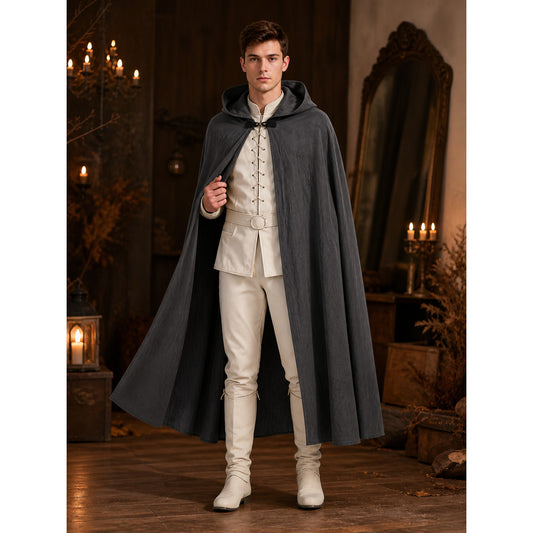 Dark gray hooded cape on a full-body male model in a candlelit interior, showing a front tie closure and long flared hem