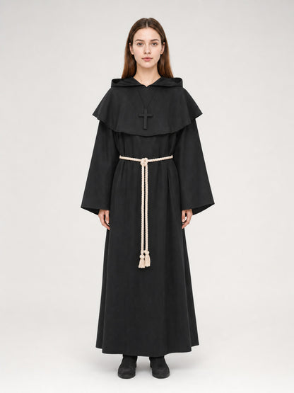 Black hooded monk robe on a full-body model, with a shoulder cape, cross pendant, wide sleeves, and cream rope belt