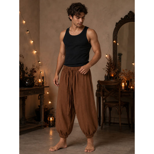 Brown cropped jogger pants with an elastic waistband and ankle cuffs, shown full-body on a model wearing a black tank top