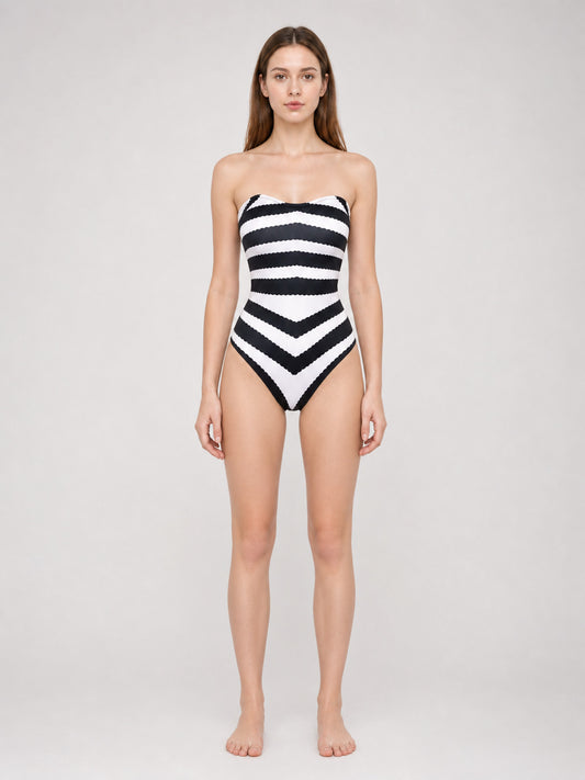 Model wearing the black-and-white striped strapless one-piece swimsuit, front view