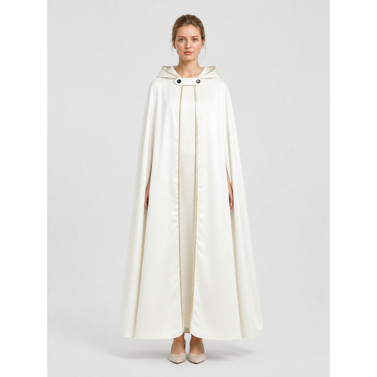 Model wearing the white satin hooded cape with gold trim, floor-length front view