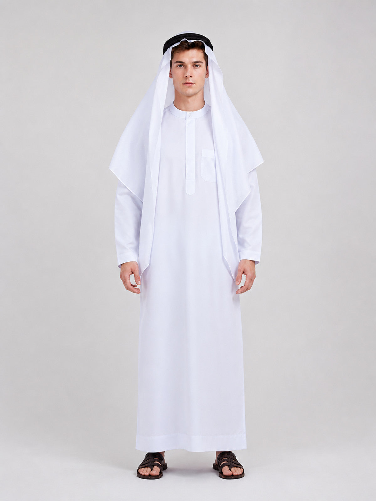 White full-length robe in smooth fabric with a draped head covering and black headband, shown full-body on a model with black sandals