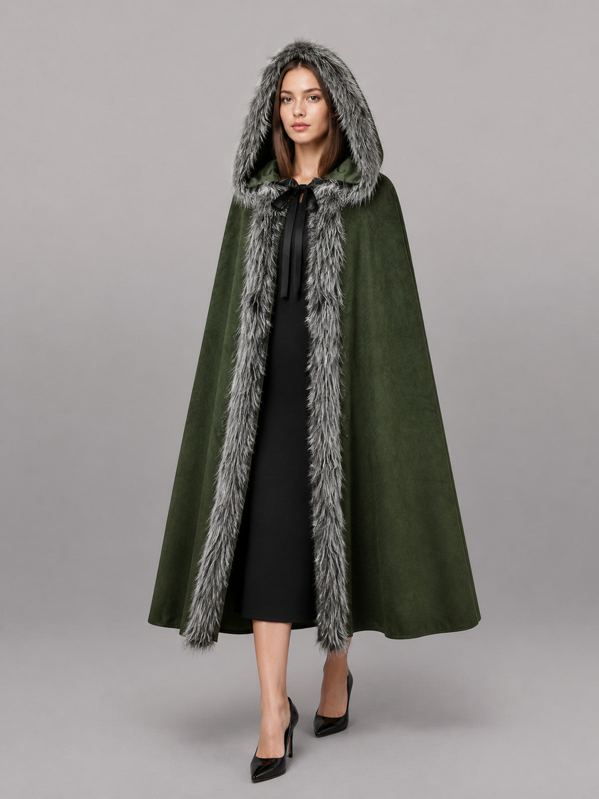 Green hooded cloak with gray fur trim, shown full-length on a model over a black dress
