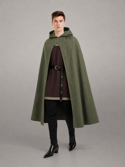 Dark olive hooded cape shown full-body on a model, with an open front, draped sides, and a black belt over a brown tunic