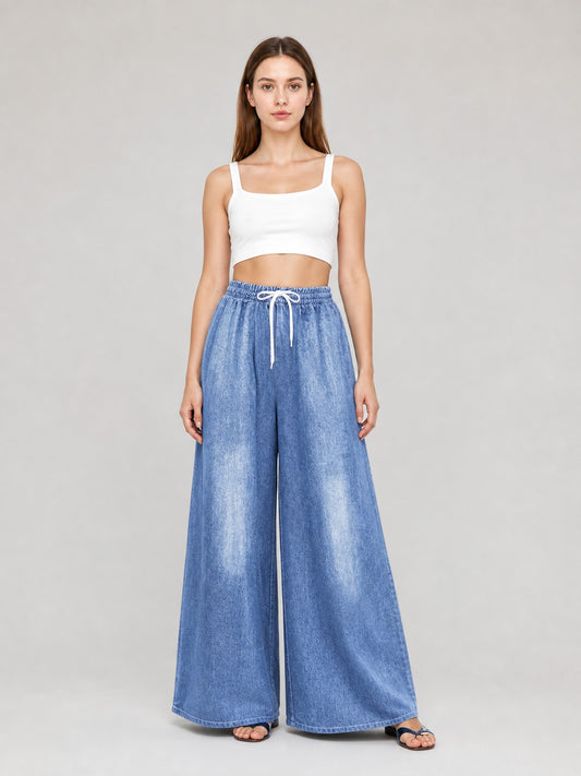 Light blue wide-leg denim pants with a high elastic waist and white drawstring, shown full-length on a model