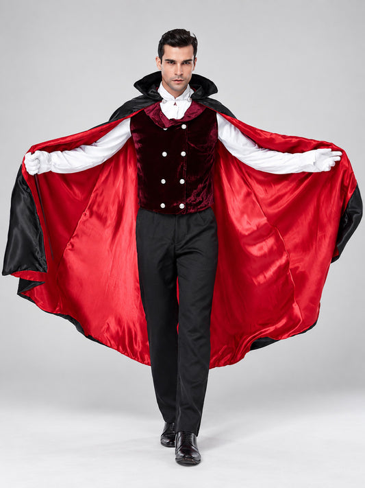 Man wearing a vampire costume set: black cape with red satin lining spread open, burgundy velvet vest, white shirt and black pants, front view
