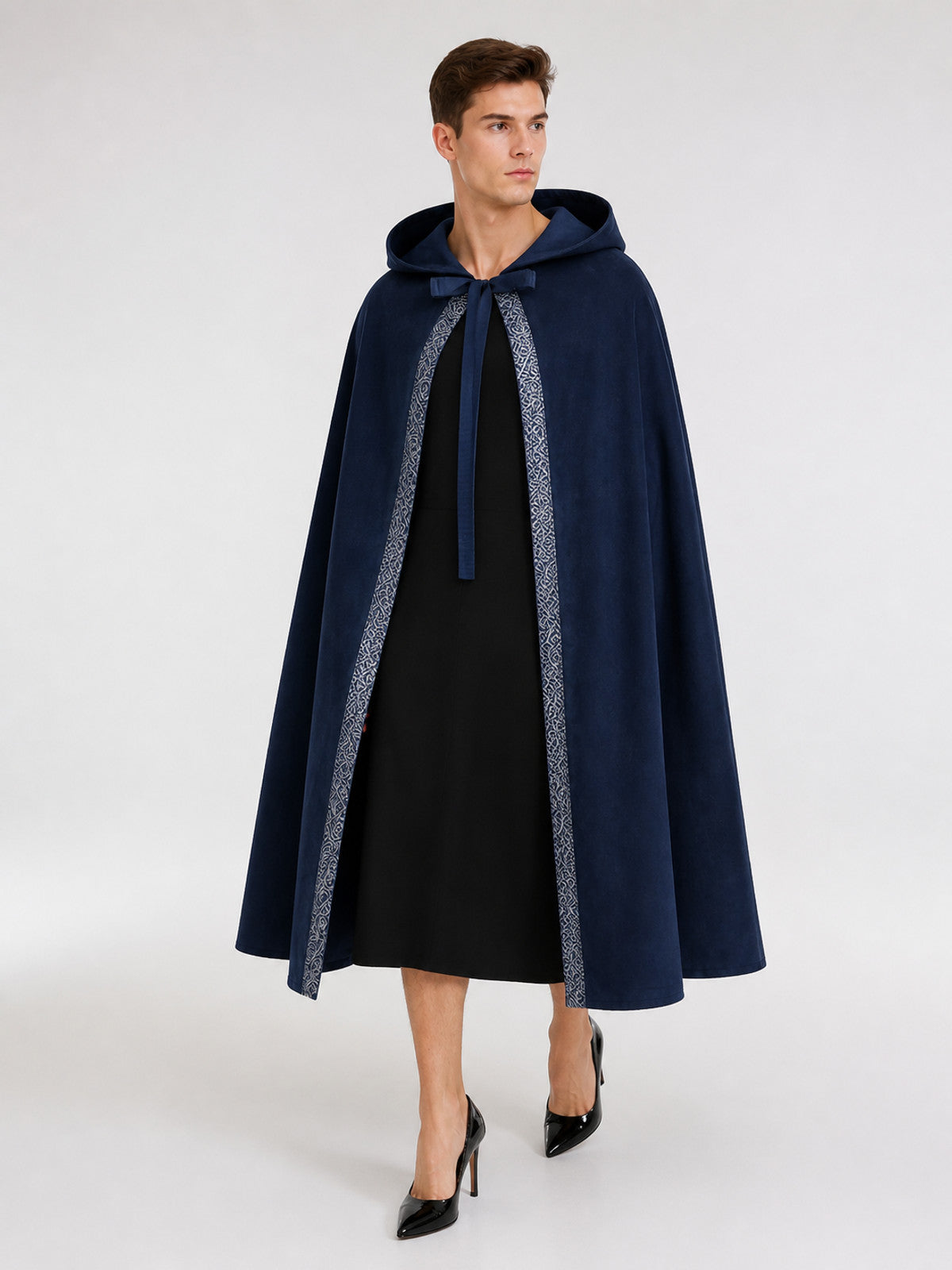 Blue hooded cloak shown full-body on a model, with a front tie and patterned light trim along the open edges