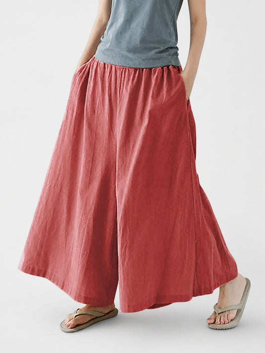Dusty rose wide-leg pants shown from the waist to ankles, with a gathered elastic waistband, side pockets, and a crinkled fabric look