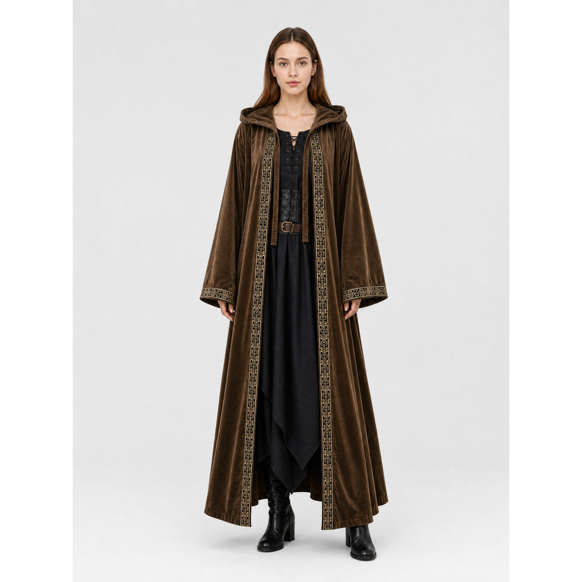 Brown velvet-look hooded cloak on a full-body model, with wide sleeves, patterned front trim, and a long open front