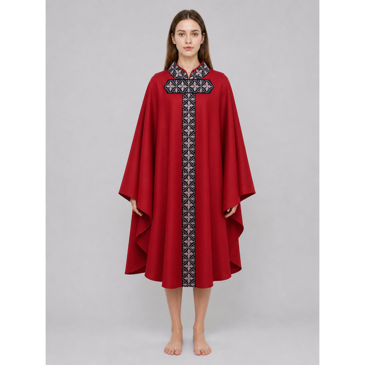 The cape is red with black decorative elements. It has a loose cloak-style silhouette, wide sleeves, and a collar with black patterned detailing. The front features a vertical decorative stripe down the center and a horizontal stripe across