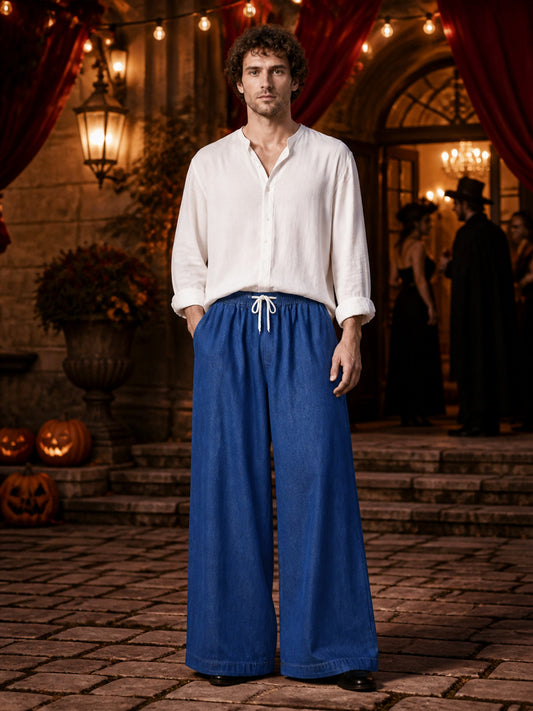 Full-body view of a man wearing dark blue wide-leg pants with a white drawstring and elastic waist