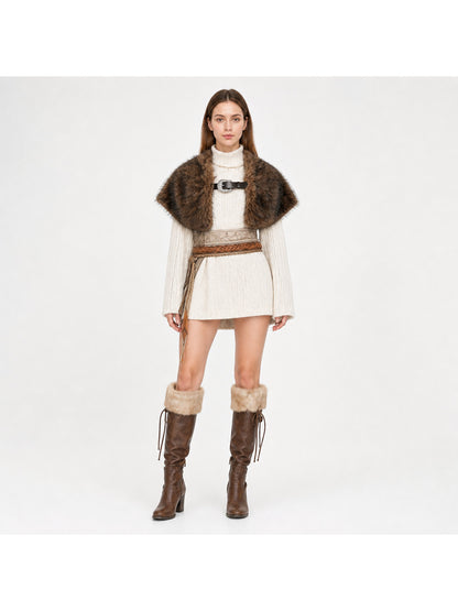 Full-body studio view of a dark brown fur-textured shoulder shawl with a black strap and silver buckle over a cream sweater