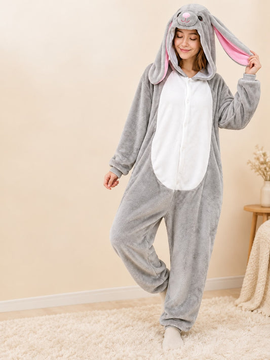Woman wearing the adult gray bunny onesie with long pink-lined floppy ears and white belly panel, front view