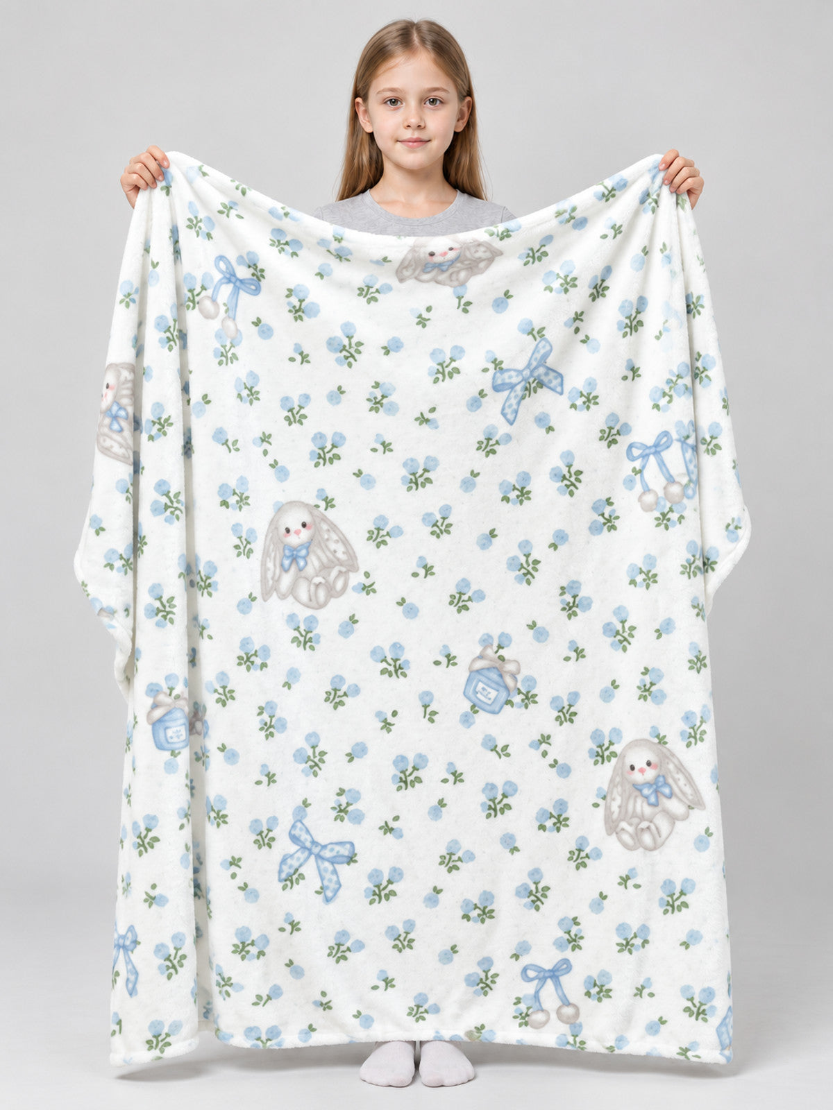 Reversible white blanket with a rabbit and bow pattern
