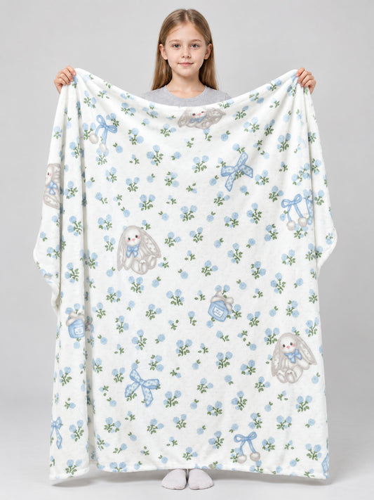 Reversible white blanket with a rabbit and bow pattern