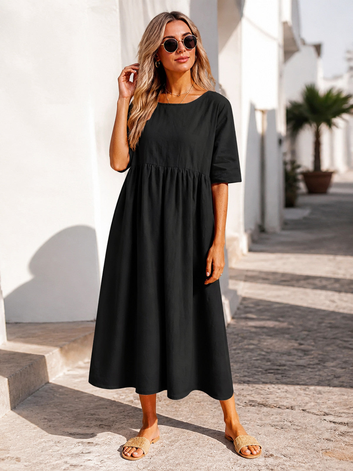 This black long dress features a round neckline, elbow-length sleeves, and a main product view