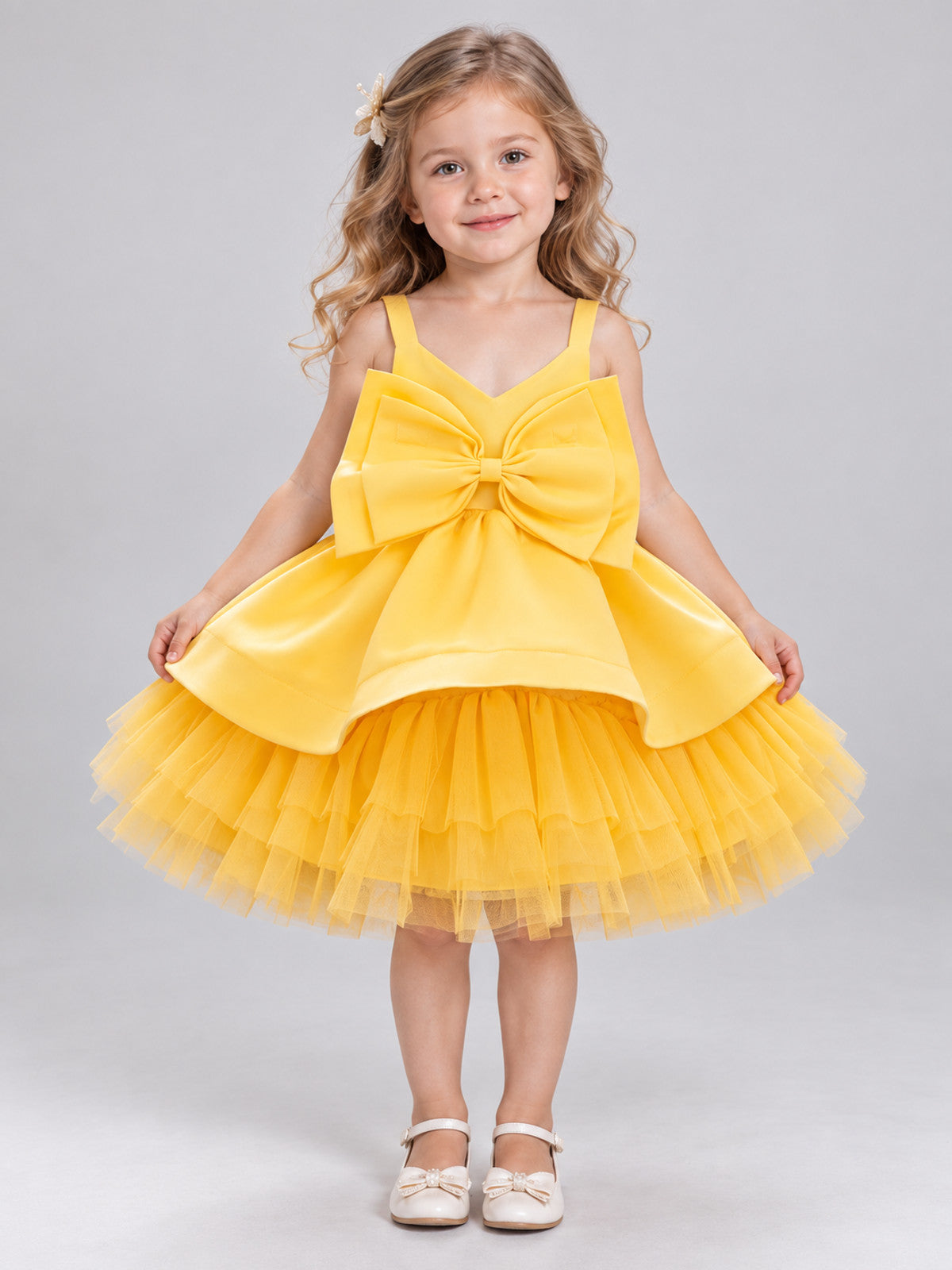 Yellow dress with a bow and a multi-layer tulle skirt