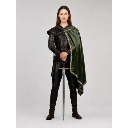 Green velvet-look asymmetrical cloak with gold-tone trim shown full length on a model with a sword