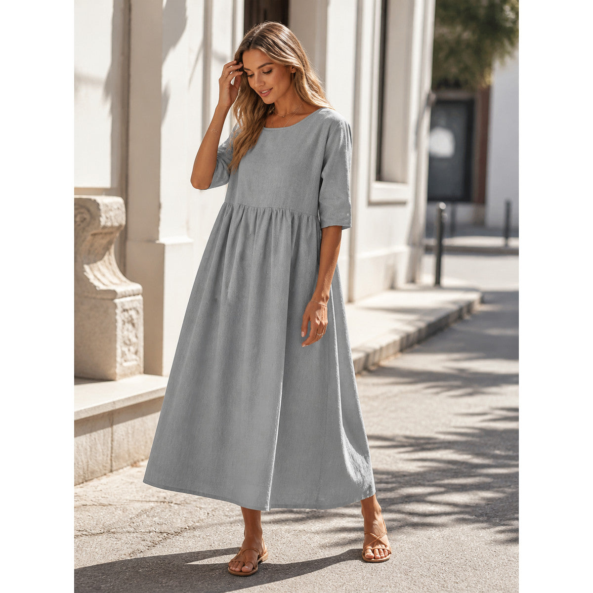 Long gray dress with 3/4 sleeves and an A-line silhouette