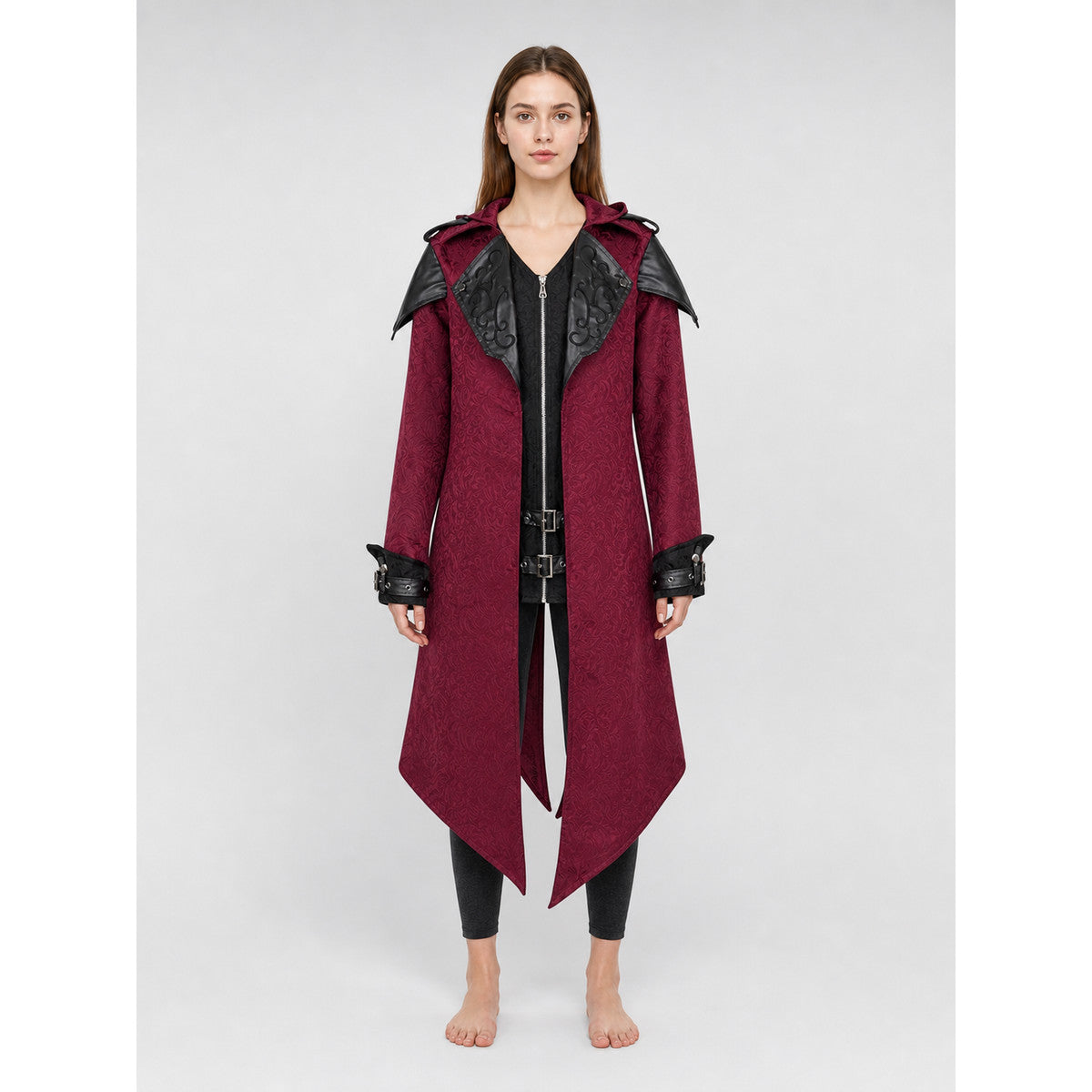 Black long gothic fantasy-style coat with decorative details, a high collar, and an asymmetrical pointed hem. The design features long sleeves and a front zipper closure. Decorative buckle straps are positioned at the waist and cuffs, while