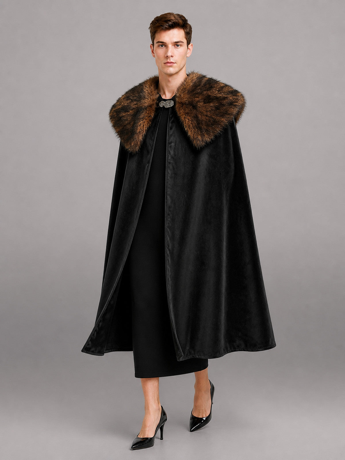 Black velvet-look cape with a wide brown fur collar, shown full-length on a model against a gray studio background