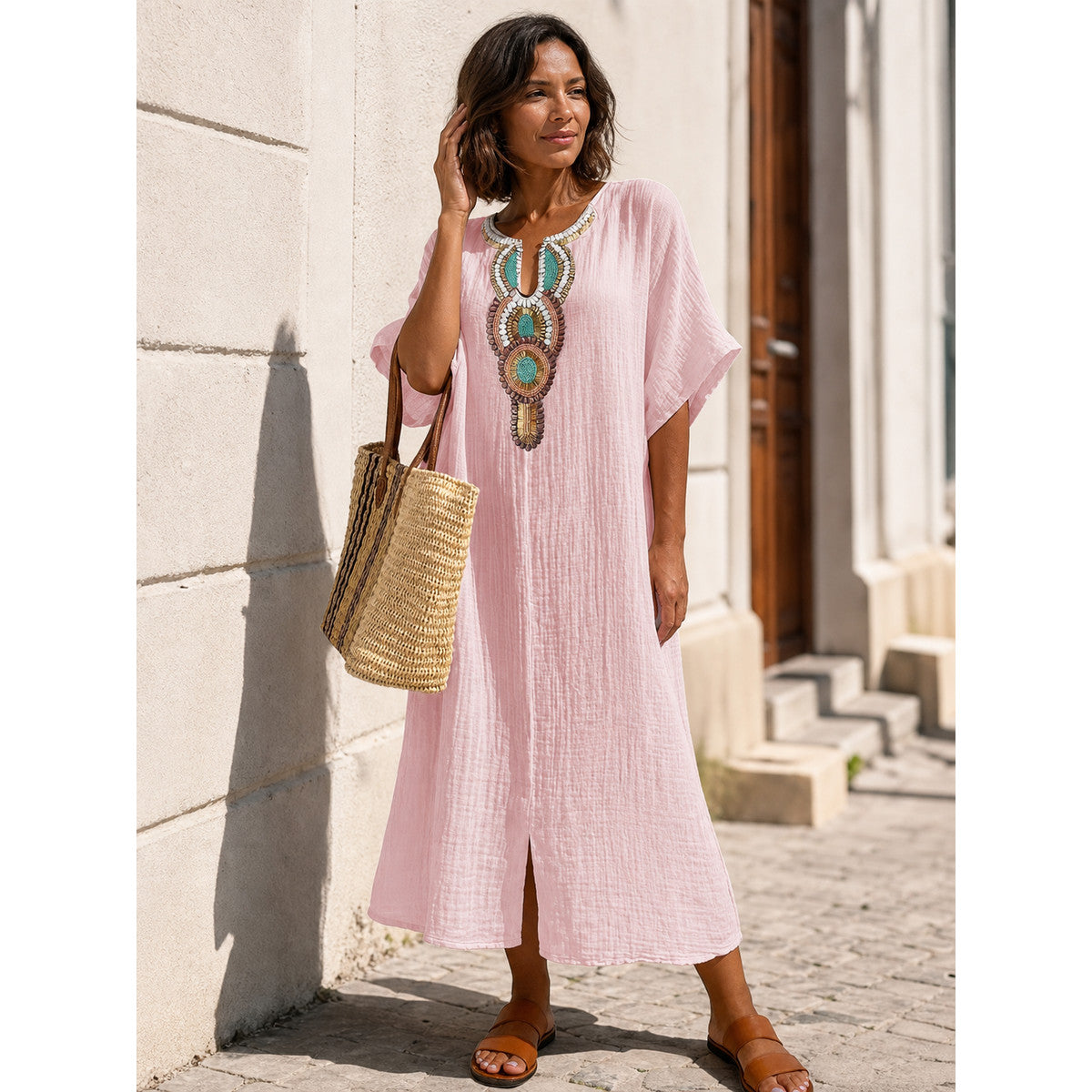 Pink loose-fit midi dress with embroidery and a slit