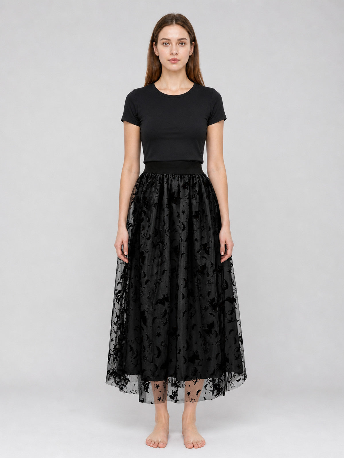 Black mesh midi skirt on a full-body model, with a gathered waistband, layered sheer overlay, and bat motifs along the hem