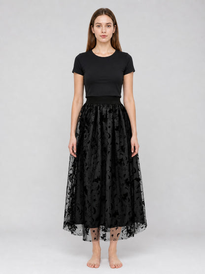 Black mesh midi skirt on a full-body model, with a gathered waistband, layered sheer overlay, and bat motifs along the hem