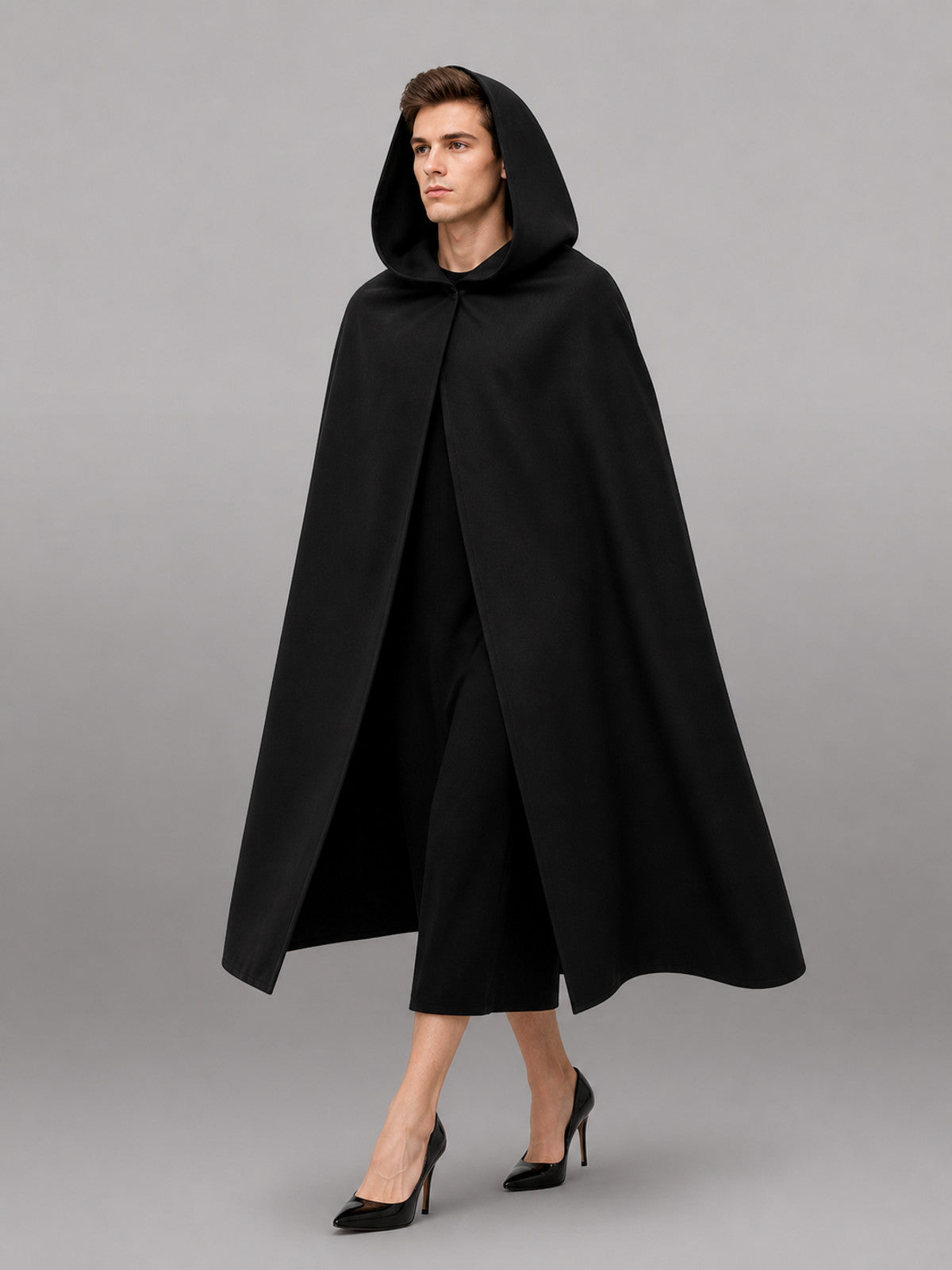 Black matte-looking hooded cloak shown full-length on a model, with a loose draped shape and open front