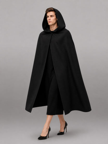 Black matte-looking hooded cloak shown full-length on a model, with a loose draped shape and open front