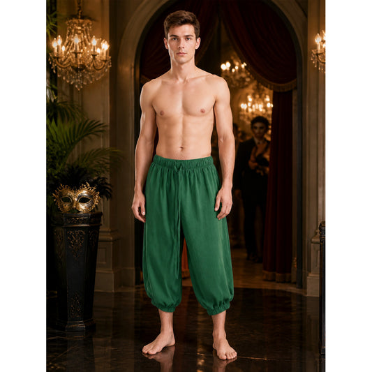 Dark green loose pants with elastic cuffs on a shirtless model in a full-body indoor portrait