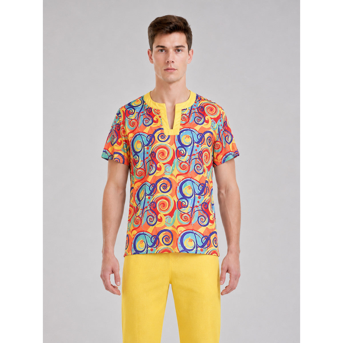 Bright 1970s Disco-Style Costume for Themed Events. The set includes a short-sleeve top, yellow flared pants, and a matching headband. The top is decorated with a multicolored swirled pattern throughout and features a V-neckline with yellow