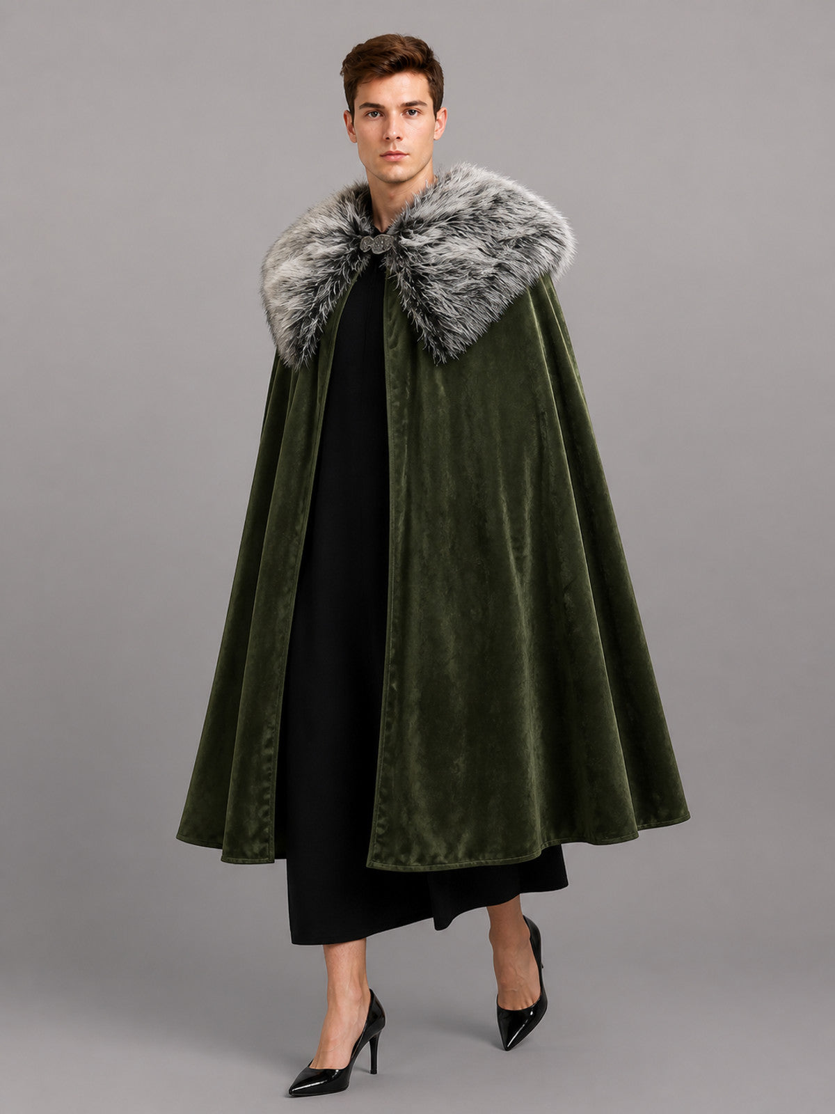 Olive green velvet-look cape with a gray faux fur collar, shown full-length on a model over black clothing