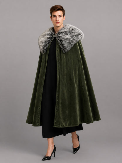 Olive green velvet-look cape with a gray faux fur collar, shown full-length on a model over black clothing