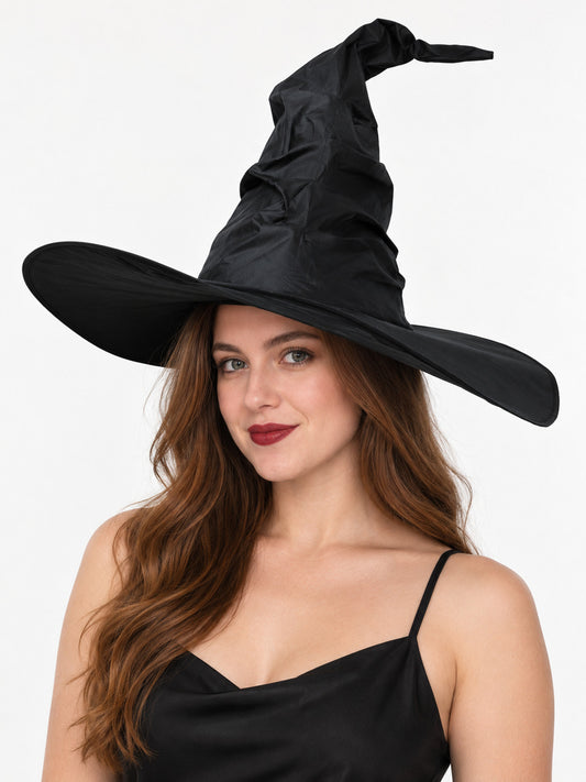 Model wearing a black witch hat with an extra-wide brim and a crinkled crown with a curved pointed tip, front view
