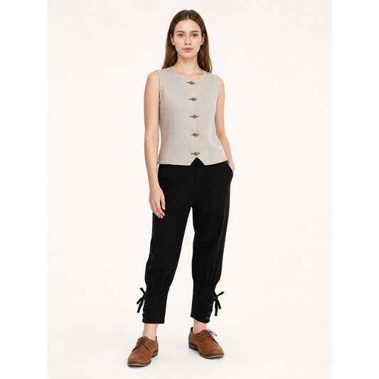 Black cropped pants on a full-body model, with tapered legs, gathered cuffs, and side drawstring ties