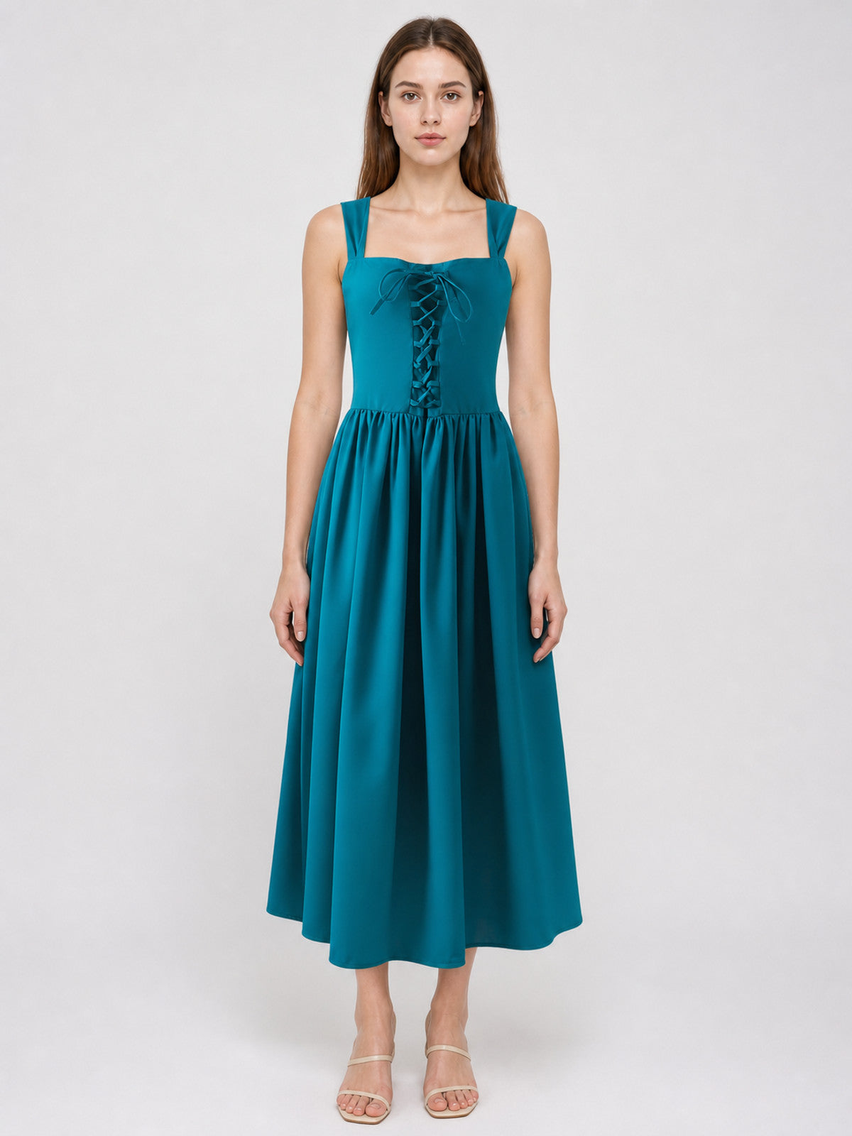 Teal dress with wide straps, front lace-up bodice, gathered waist, and flowing midi skirt shown full-body on a model