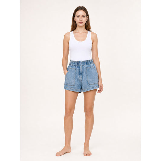 Light blue denim shorts shown full-body on a model, with an elastic high-rise waistband and large front patch pockets