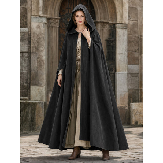 Black hooded cloak shown full-body on a model, with a wide flowing hem and front opening over a beige dress