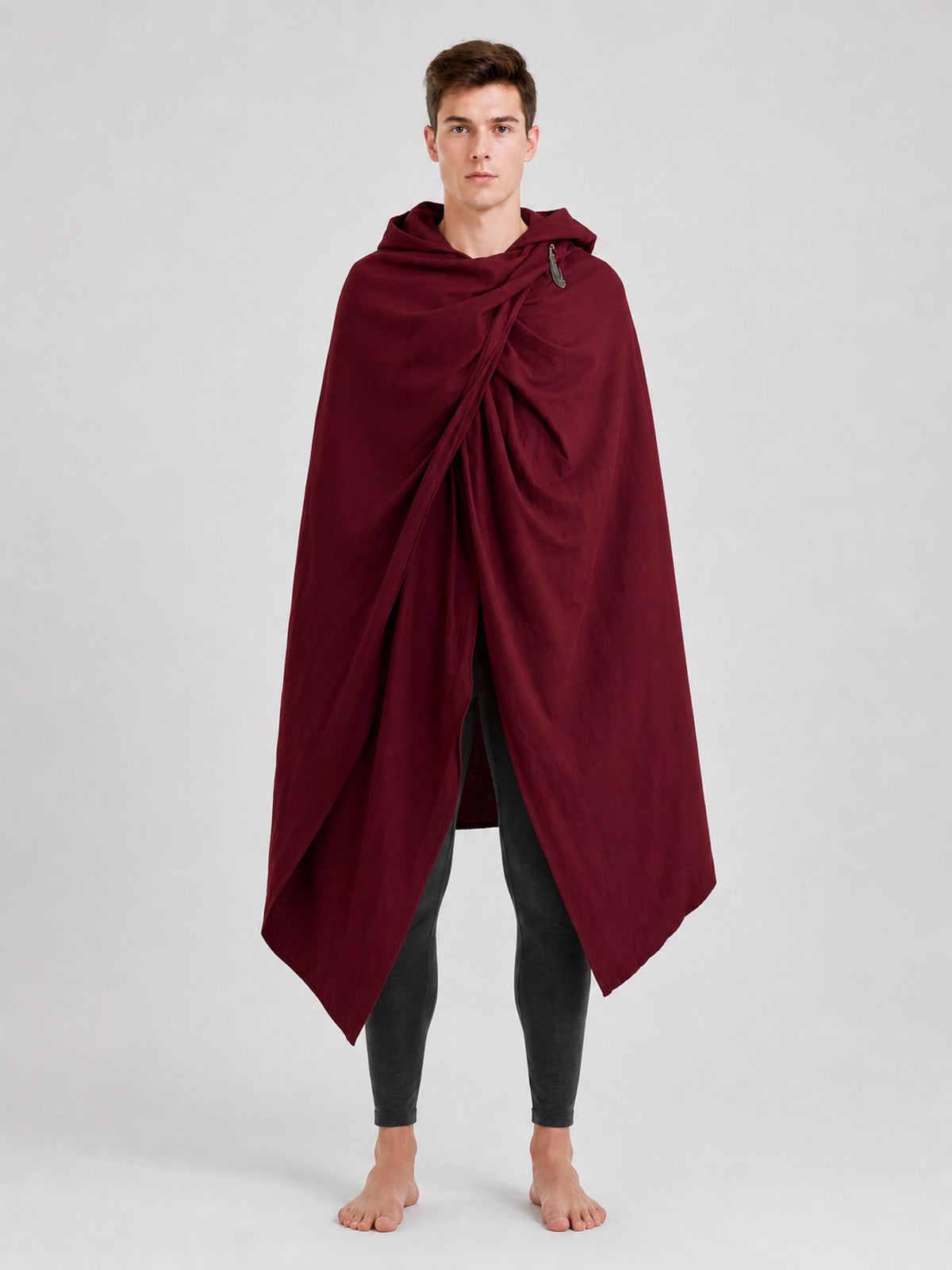 Burgundy hooded cloak with gathered front and shoulder fastener, shown full length on a male model in a studio