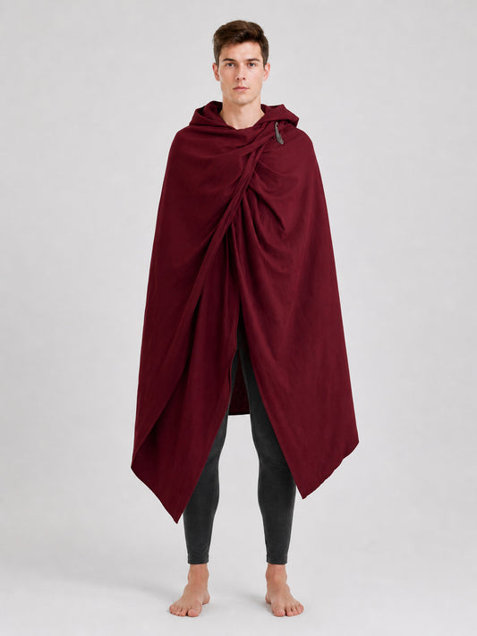 Burgundy hooded cloak with gathered front and shoulder fastener, shown full length on a male model in a studio