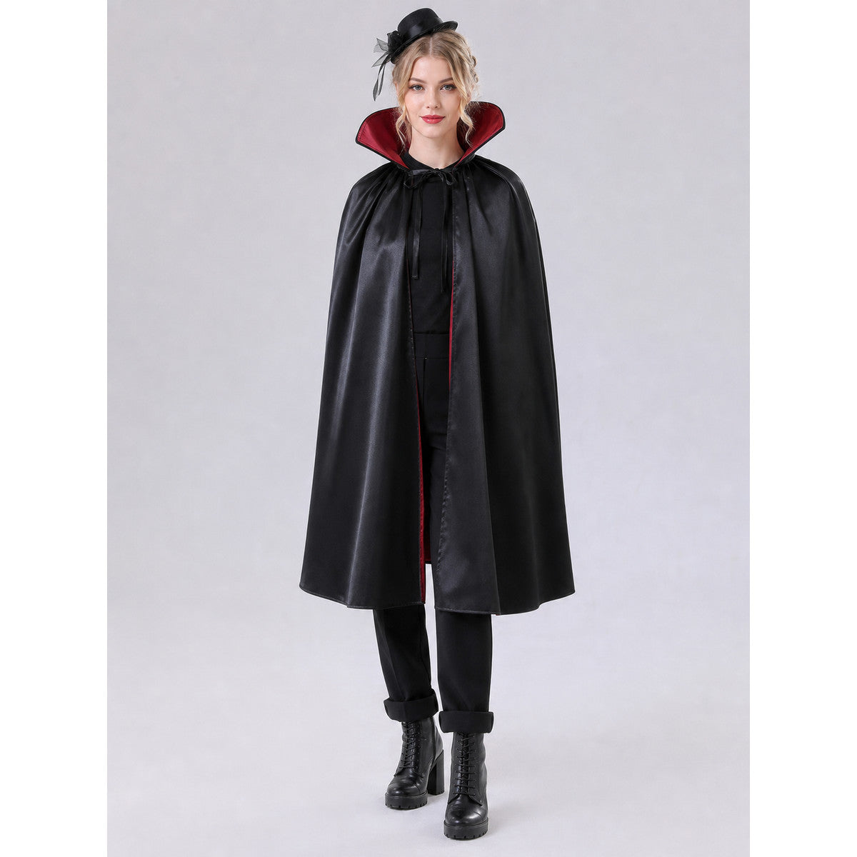 The long black cape is designed to create a vampire look for cosplay, Halloween, and stage performances. The cape is black and features a loose silhouette with long, draping panels and an opening lower edge. The upper section has a hooded o