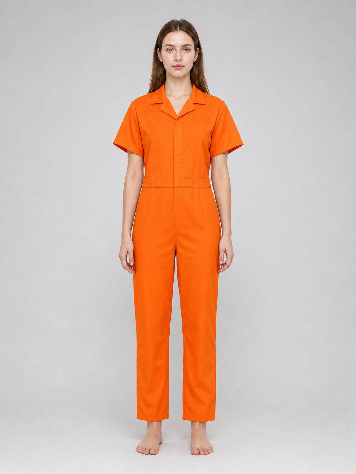 Orange short-sleeve jumpsuit with a collar, shown full-body on a model against a plain gray background