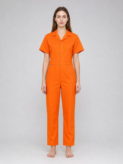 Orange short-sleeve jumpsuit with a collar, shown full-body on a model against a plain gray background