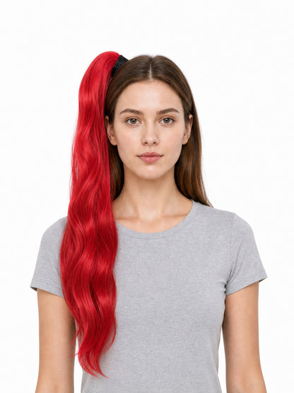 Red wavy ponytail hairpiece shown on a front-facing model, extending past her waist with a dark attachment at the top